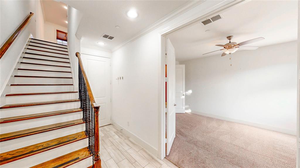 620 South Pearl Expressway Dallas, TX 75201 - Photo 5 of 33 a view of a hallway with a white walls and a ceiling fan