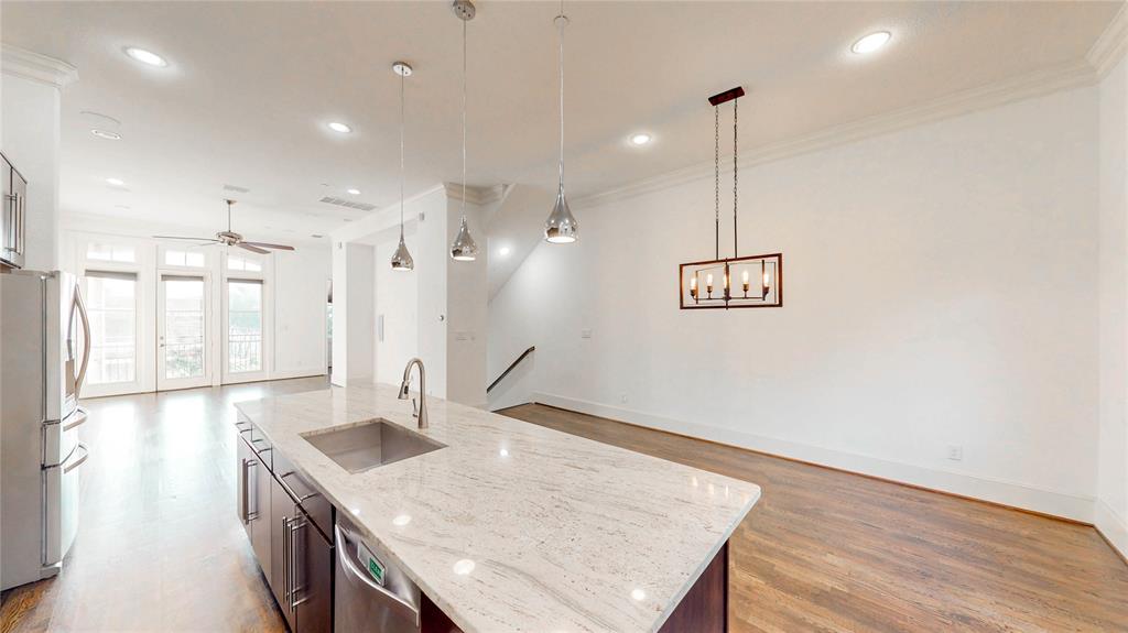 620 South Pearl Expressway Dallas, TX 75201 - Photo 10 of 33 a kitchen with kitchen island white cabinets and wooden floor