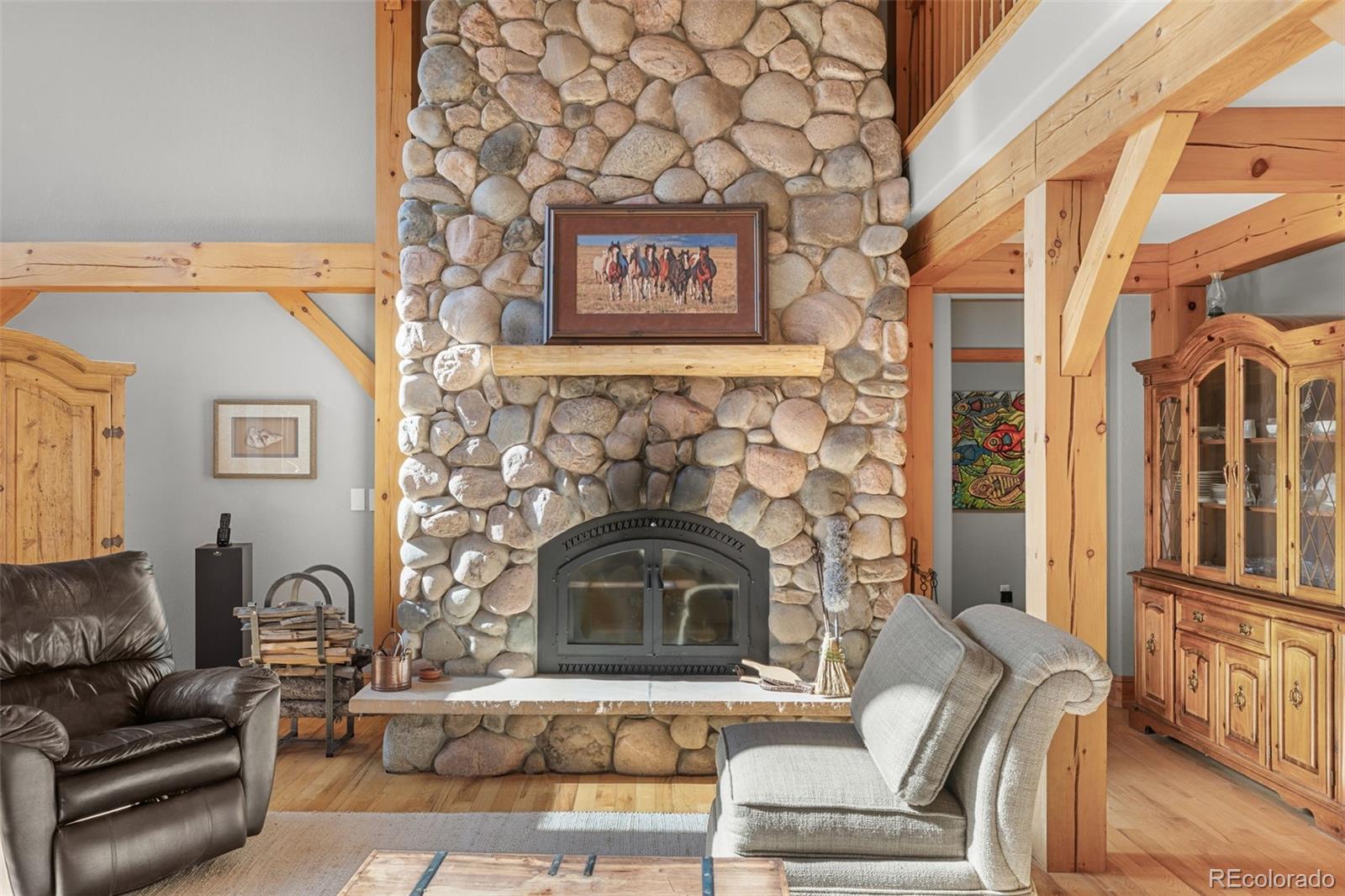 13445 Baird Road Conifer, CO 80433 - Photo 11 of 50 a living room with furniture and a fireplace