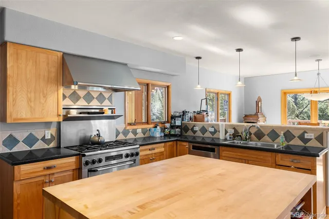 a kitchen with stainless steel appliances a sink and a stove