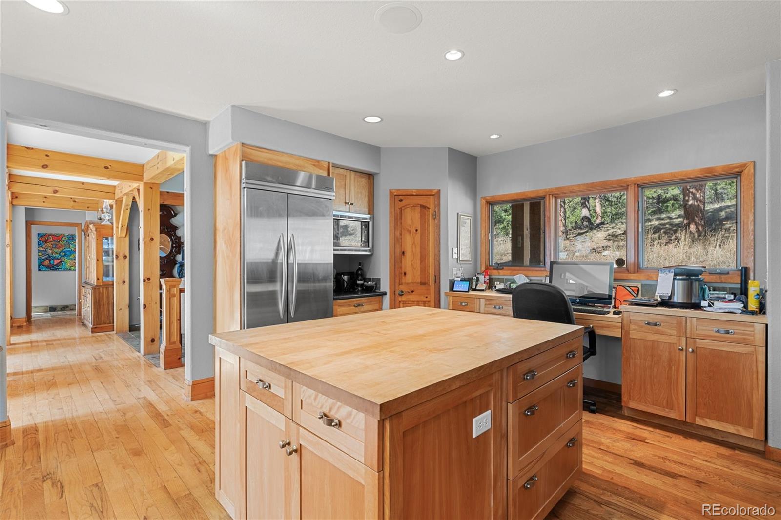 13445 Baird Road Conifer, CO 80433 - Photo 22 of 50 a kitchen with stainless steel appliances kitchen island granite countertop a refrigerator a stove top oven and a view of living room