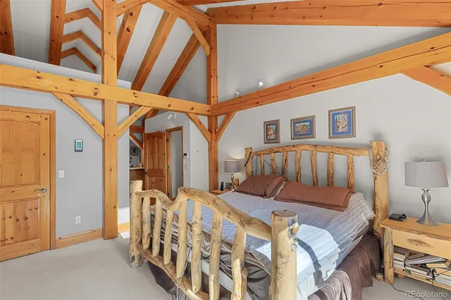 a bedroom with furniture and a large window