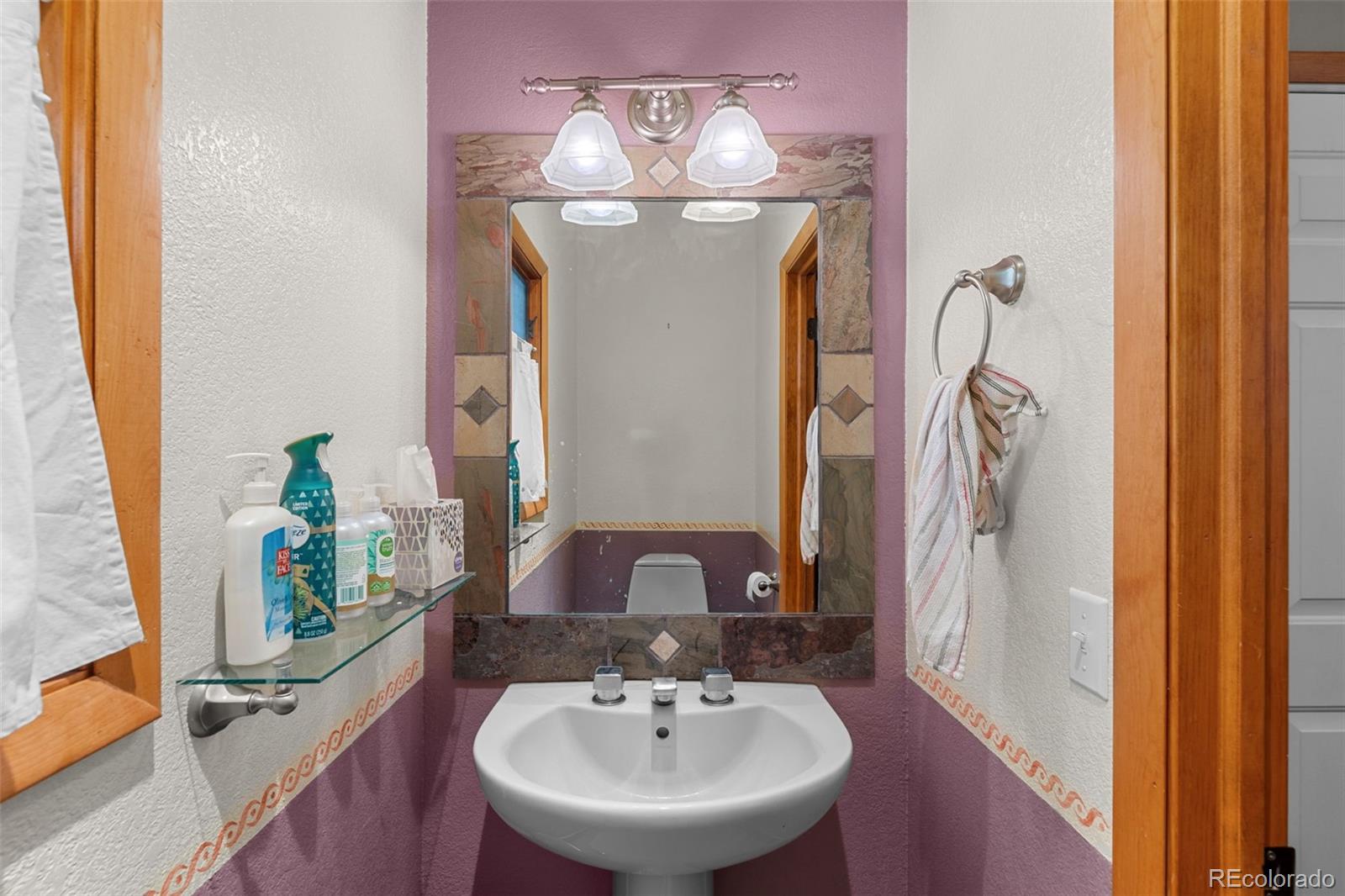 13445 Baird Road Conifer, CO 80433 - Photo 31 of 50 a bathroom with a sink and a mirror