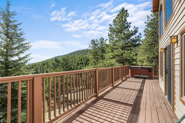 a view of balcony with wooden floor and fence