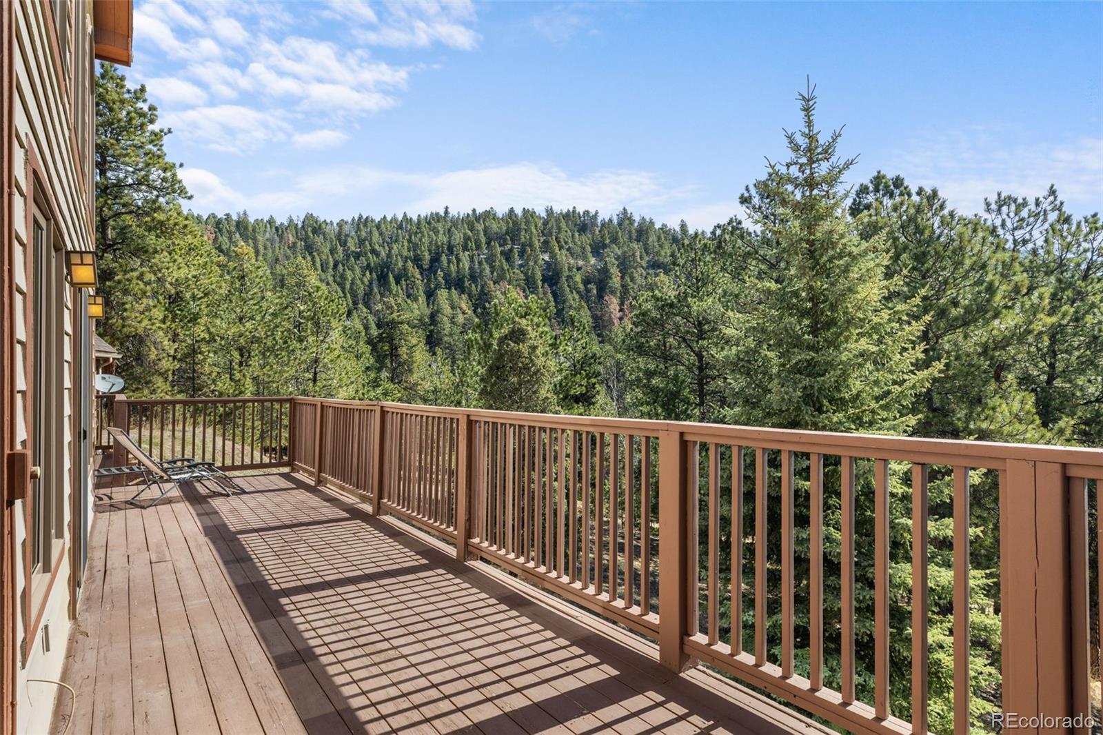 13445 Baird Road Conifer, CO 80433 - Photo 35 of 50 a balcony with wooden floor and fence