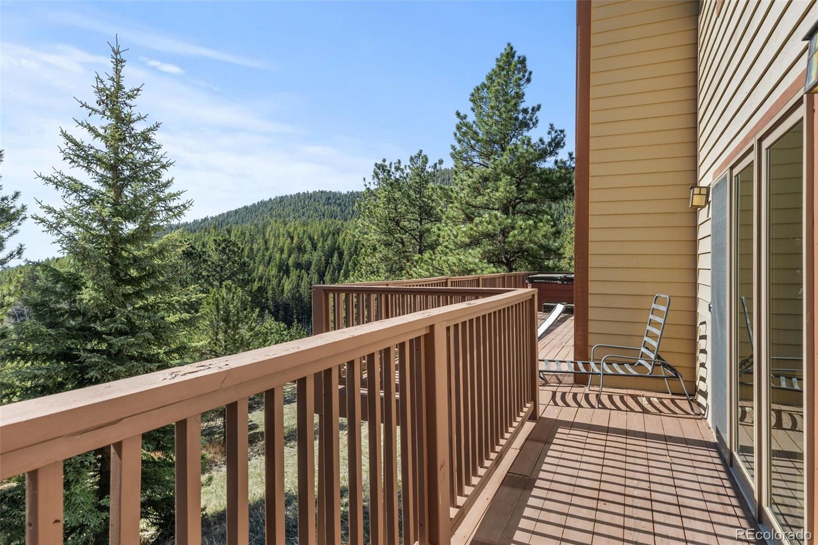 13445 Baird Road Conifer, CO 80433 - Photo 36 of 50 a balcony with wooden floor and fence
