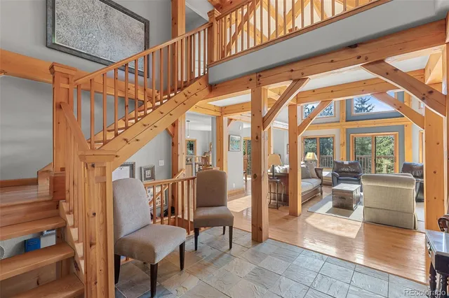 a view of entryway and hall with wooden floor and a potted plant