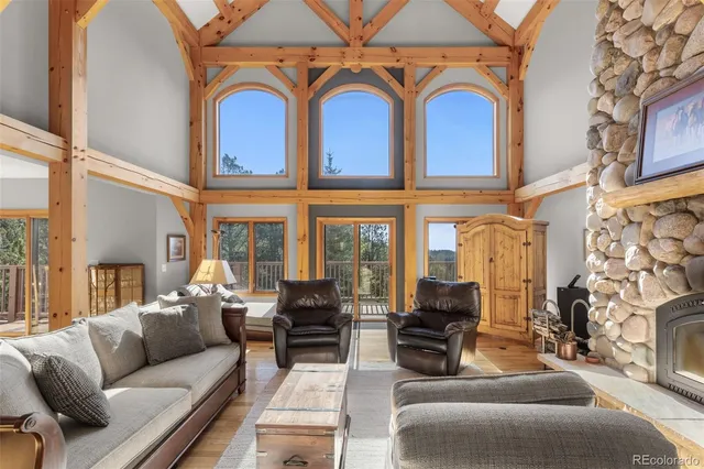 a living room with furniture fireplace and a large window