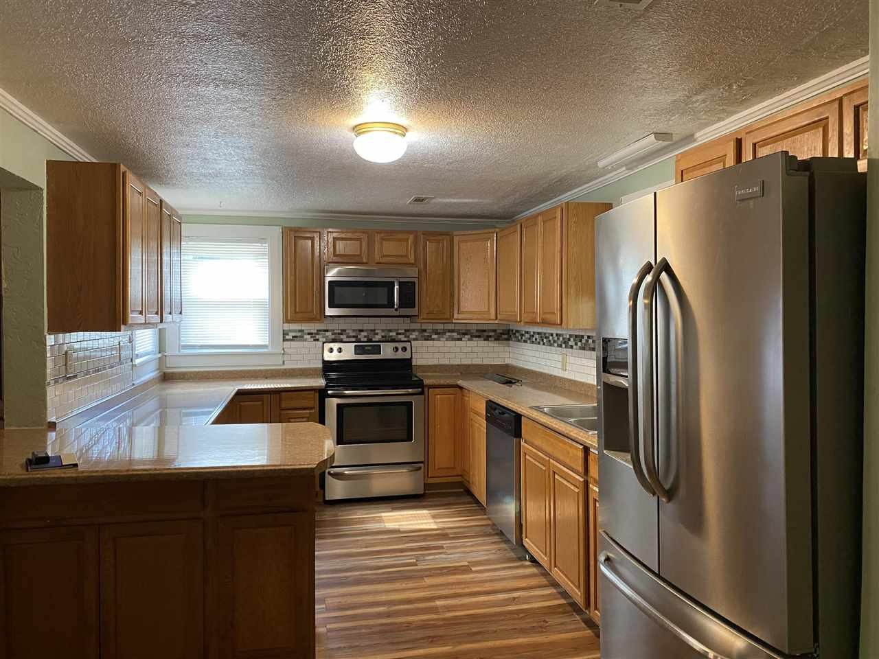 113 Jordan Street Rutherford, TN 38369 - Photo 5 of 14 a kitchen with granite countertop a refrigerator stove and sink