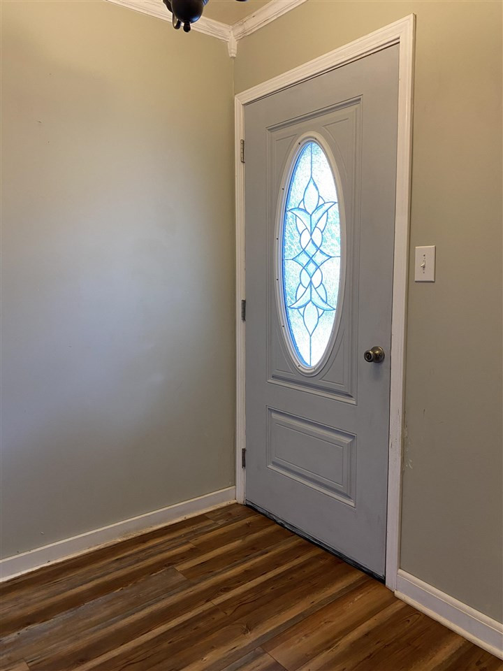 113 Jordan Street Rutherford, TN 38369 - Photo 6 of 14 an empty room with wooden floor cabinet and mirror