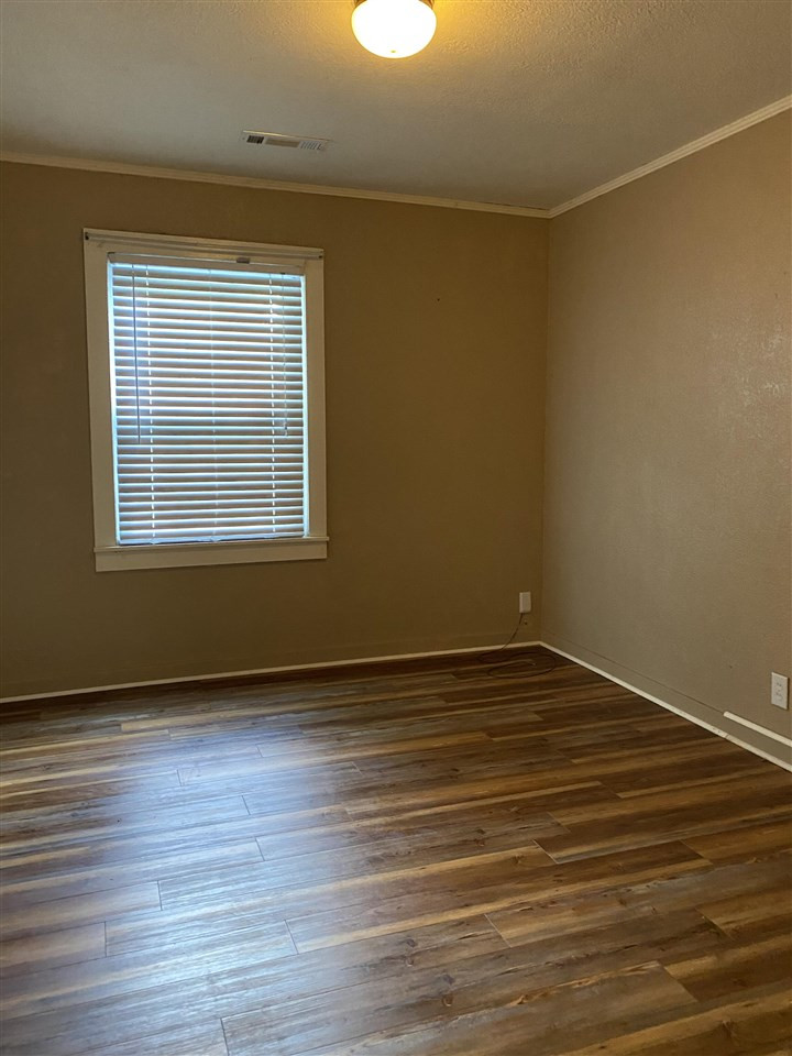 113 Jordan Street Rutherford, TN 38369 - Photo 10 of 14 a view of an empty room with wooden floor and a window