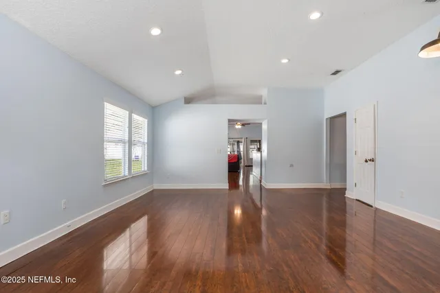 a view of wooden floor and windows in a room