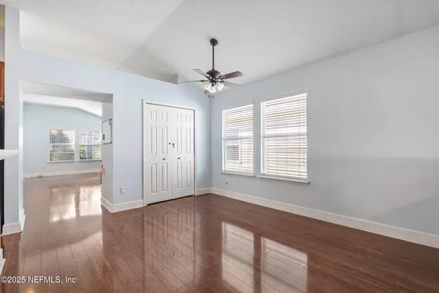 a kitchen with stainless steel appliances granite countertop a stove a sink dishwasher and a refrigerator with wooden floor