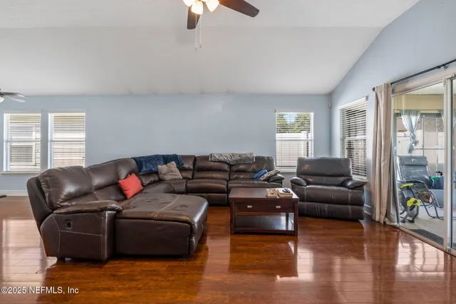 a spacious bedroom with a bed and wooden floor