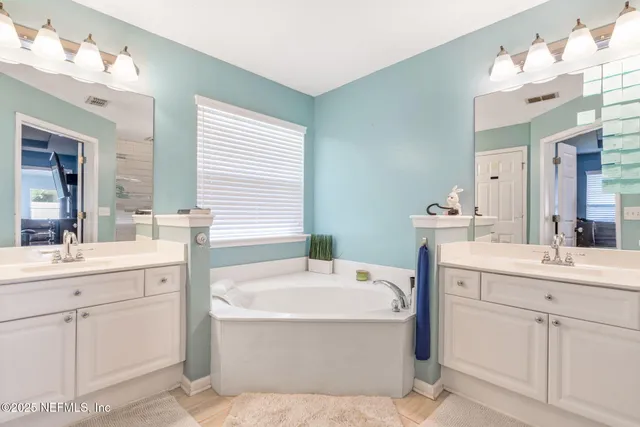 a view of a backyard with a garden and entertaining space