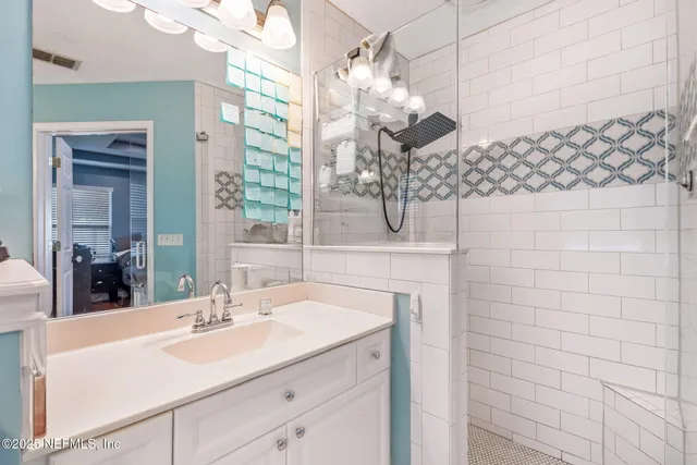 a bathroom with a sink vanity and a mirror