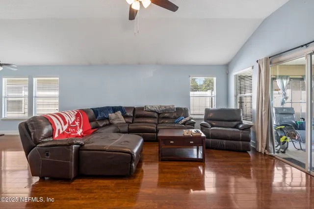 a living room with furniture and wooden floor
