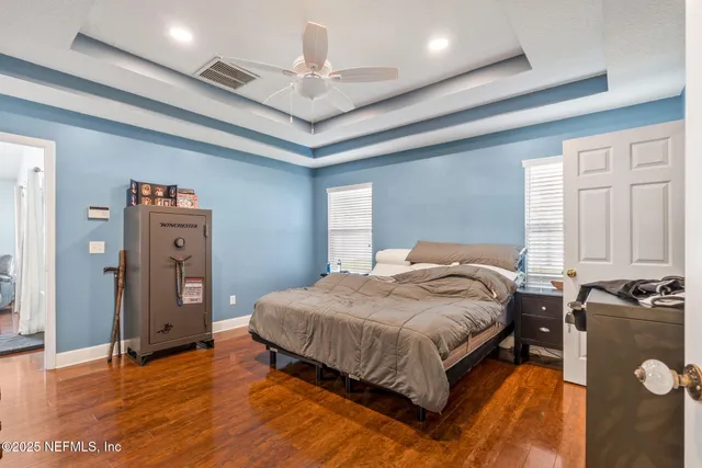 a view of a livingroom with furniture wooden floor and a window