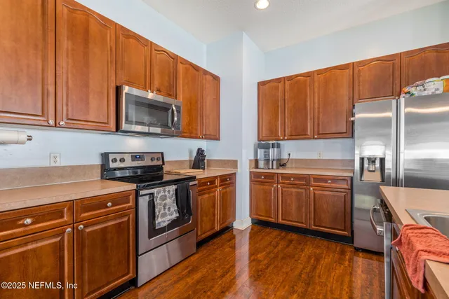 a view of a workspace with furniture and wooden floor