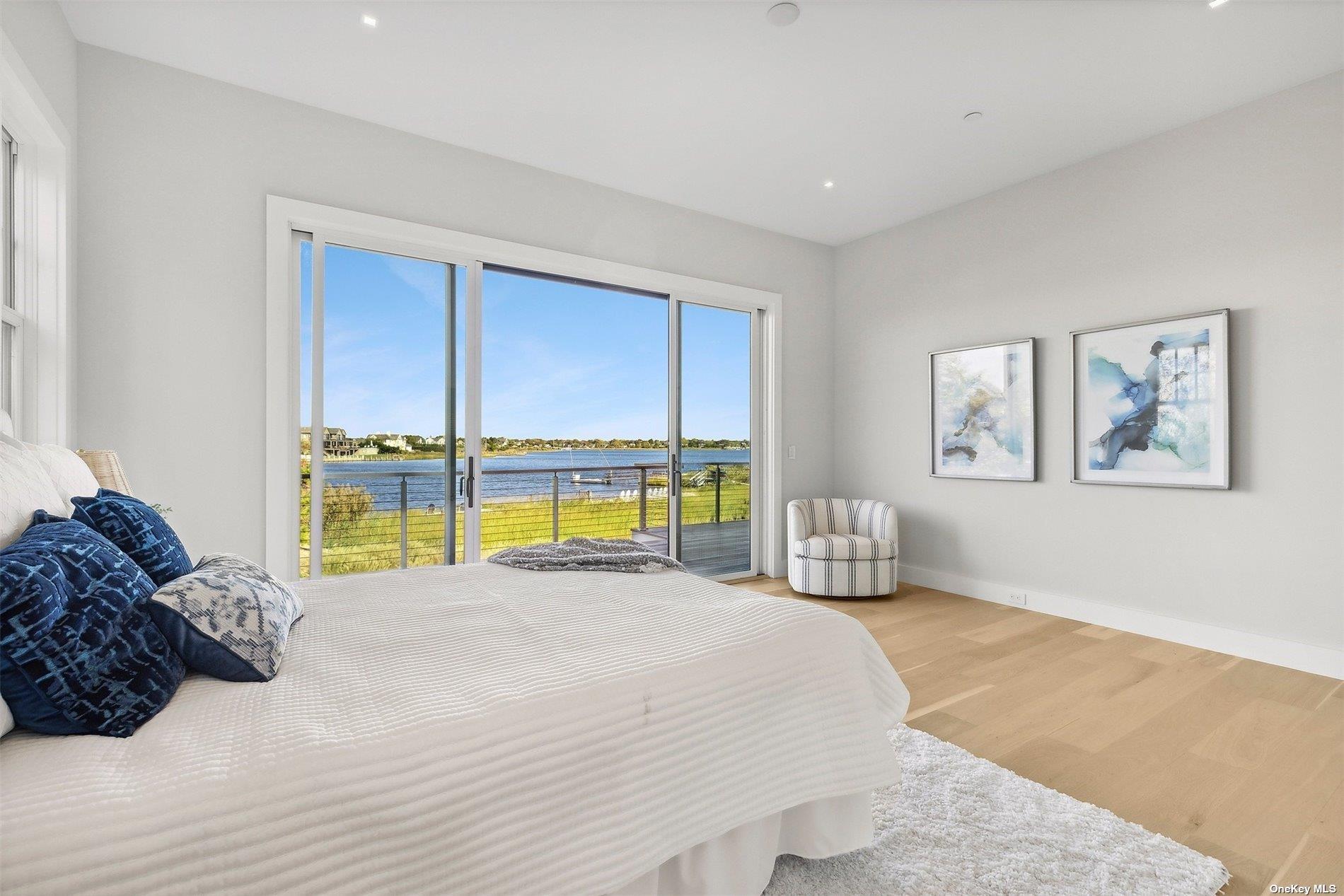 218 Dune Road Westhampton Beach, NY 11978 - Photo 16 of 25 a bedroom with a bed and a large window