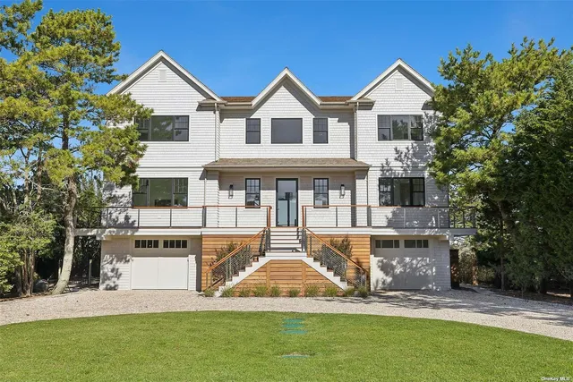 a front view of a house with a yard table and chairs