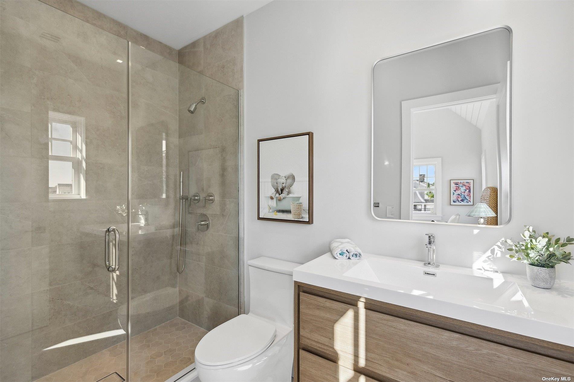 218 Dune Road Westhampton Beach, NY 11978 - Photo 23 of 25 a bathroom with a sink a toilet and shower