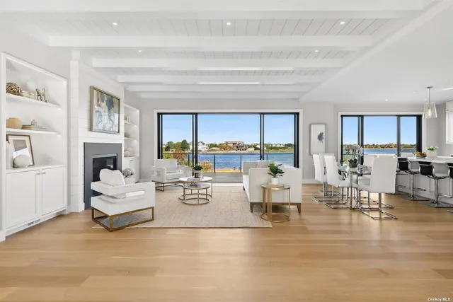 a kitchen with a stove a sink a kitchen island with a dining table and chairs