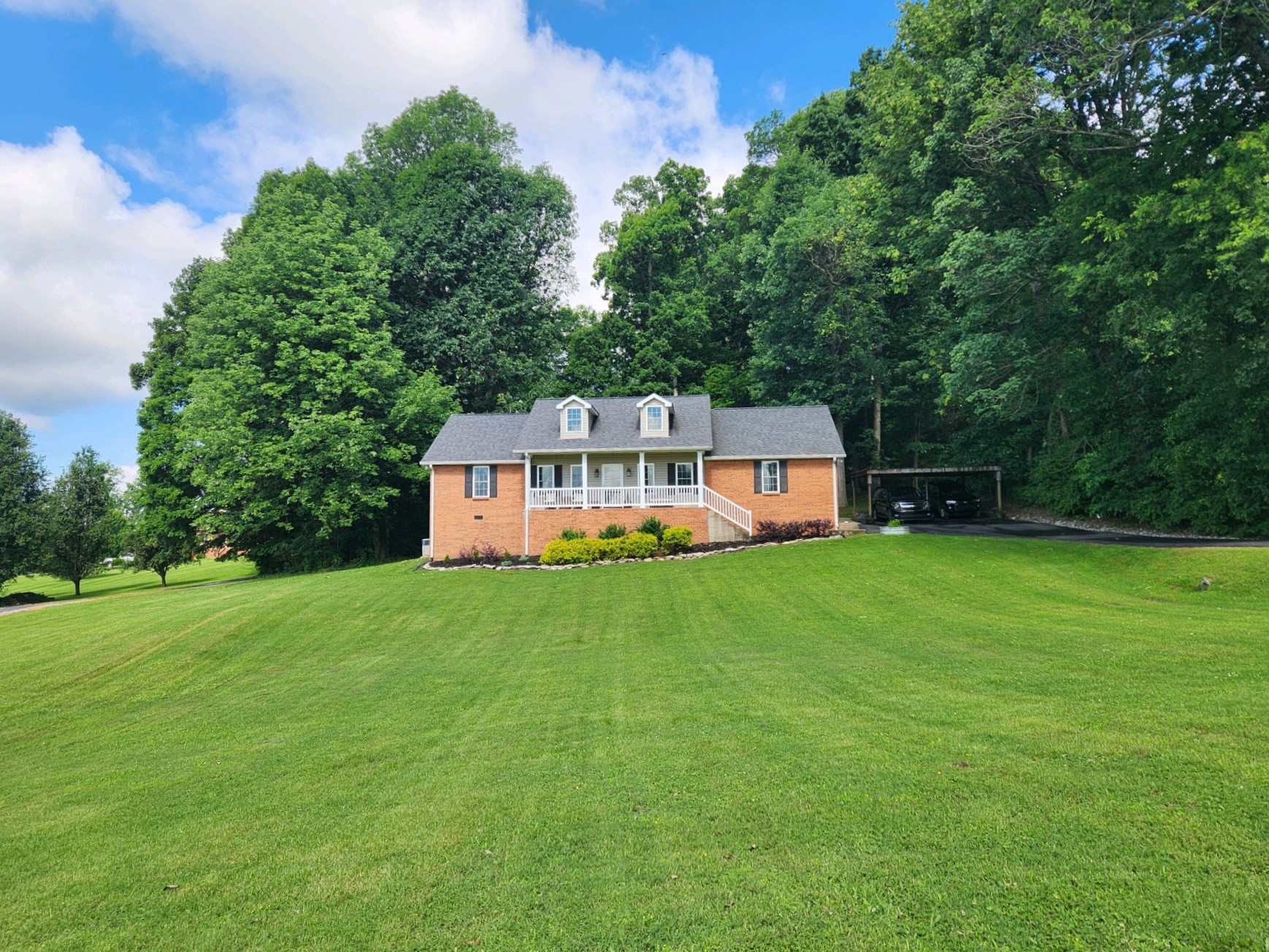 830 Bates Road Lebanon, TN 37087 - Photo 4 of 41 a view of a big house with a big yard and large trees