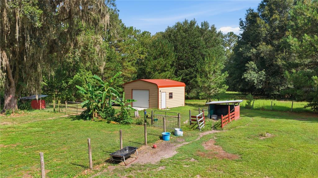 17900 Northwest 120th Avenue Road Reddick, FL 32686 - Photo 7 of 45 a backyard of a house with table and chairs