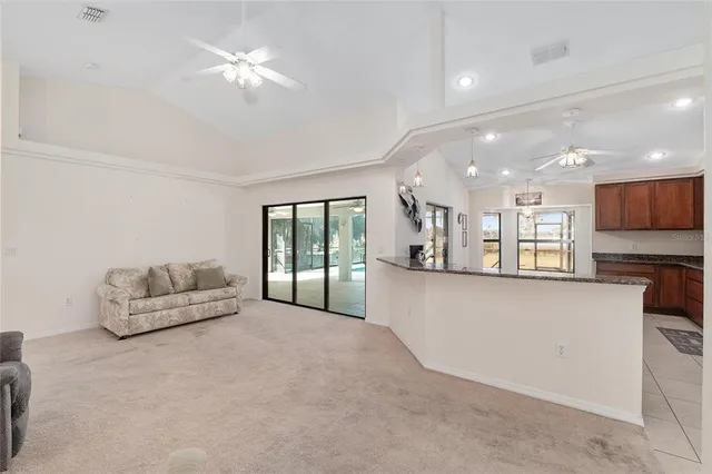 a kitchen with stainless steel appliances granite countertop a refrigerator a stove and a sink