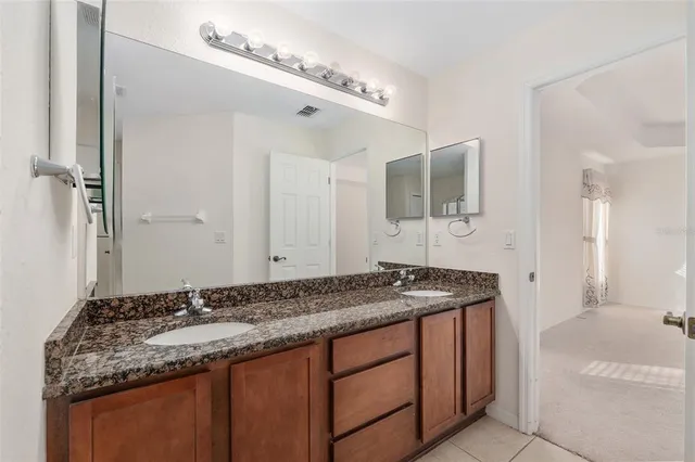 a view of a small space with a chandelier fan