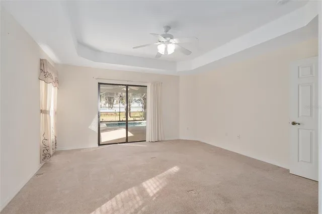 a view of a livingroom with lounge chair and a bookshelf