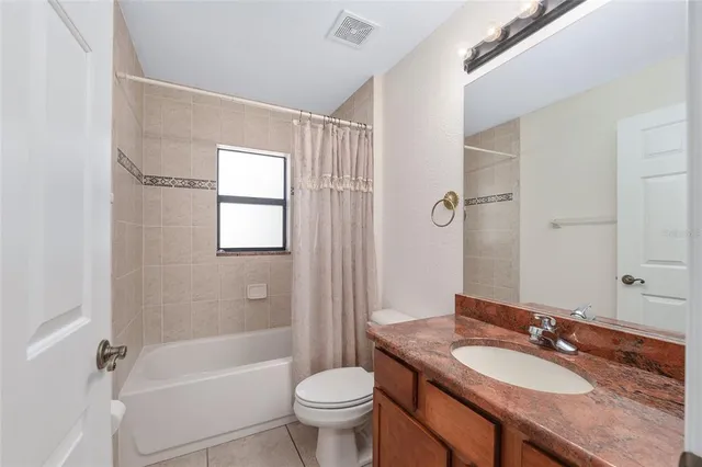 a view of a hallway with wooden floor and a living room