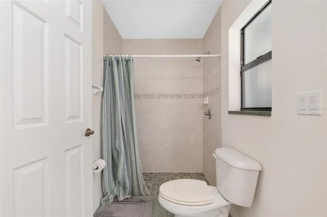 a view of a yard with wooden fence