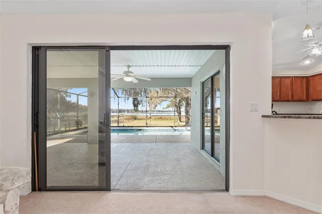 a front view of a house with a yard and large trees