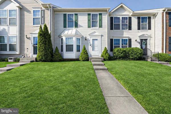 a front view of a building with a yard