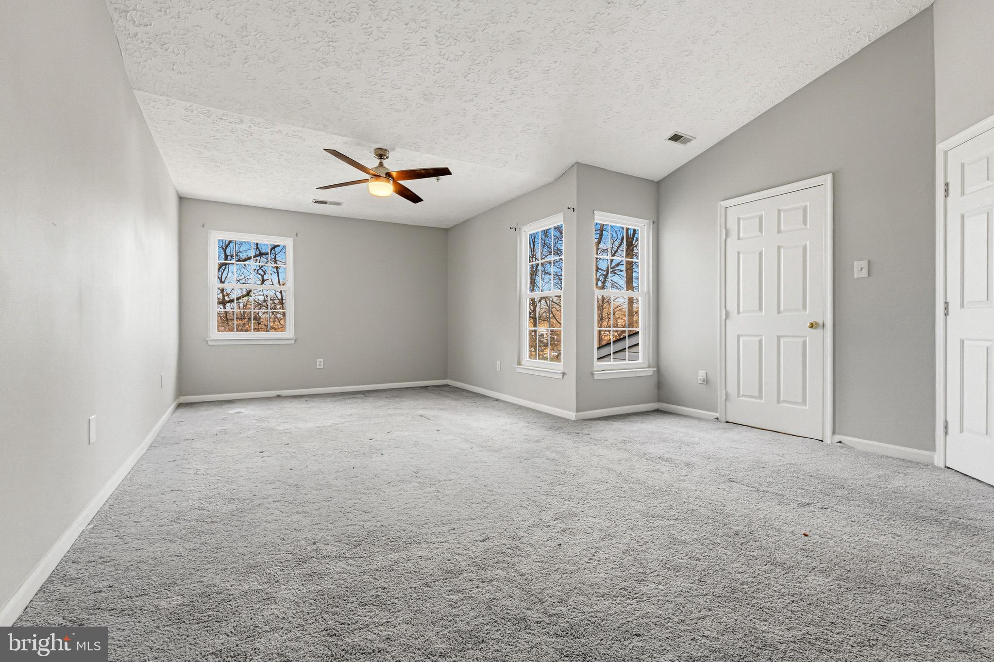 536 MacIntosh Circle Joppa, MD 21085 - Photo 12 of 32 an empty room with windows and ceiling fan
