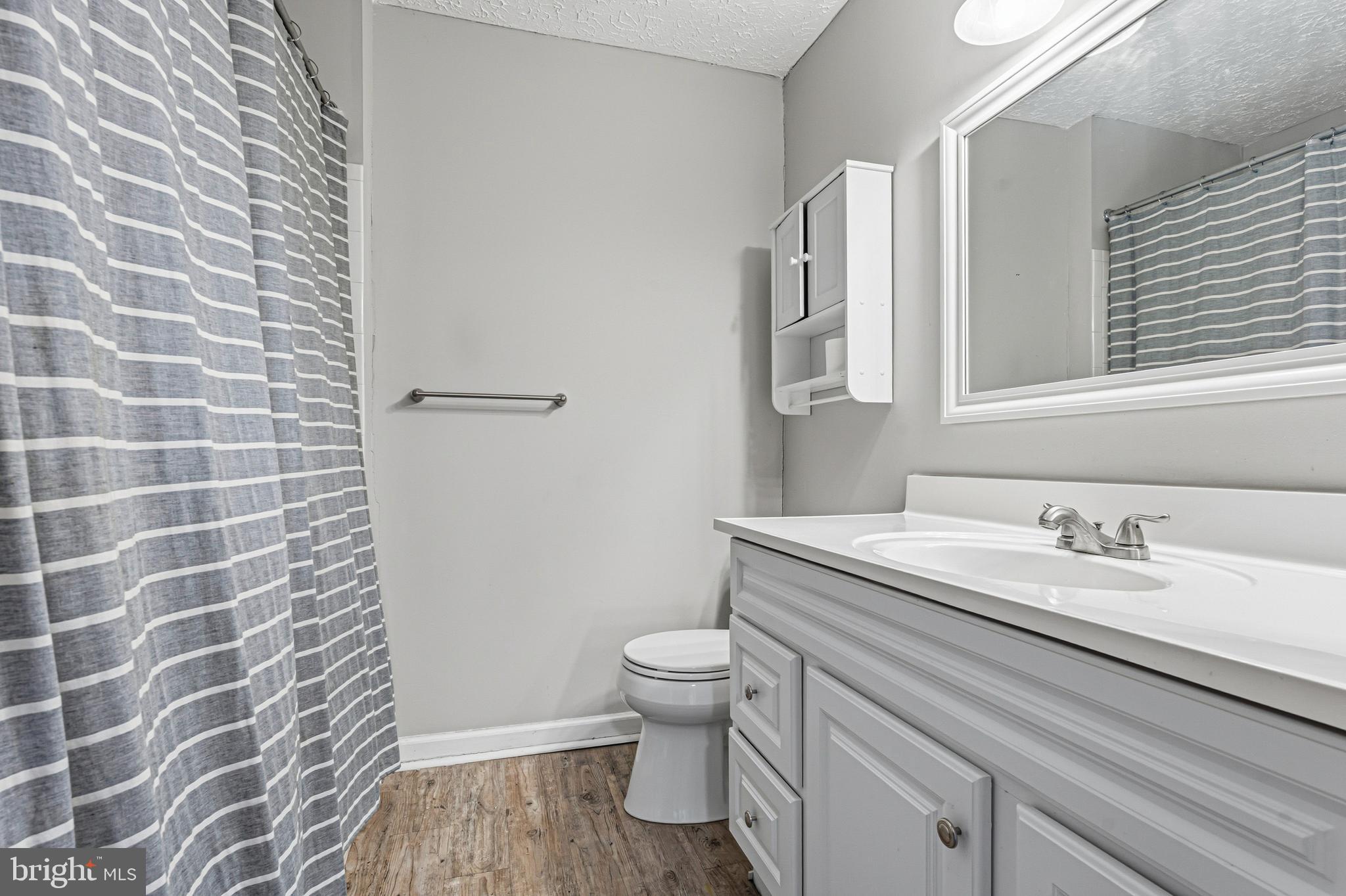 536 MacIntosh Circle Joppa, MD 21085 - Photo 15 of 32 a bathroom with a granite countertop sink a toilet and a mirror