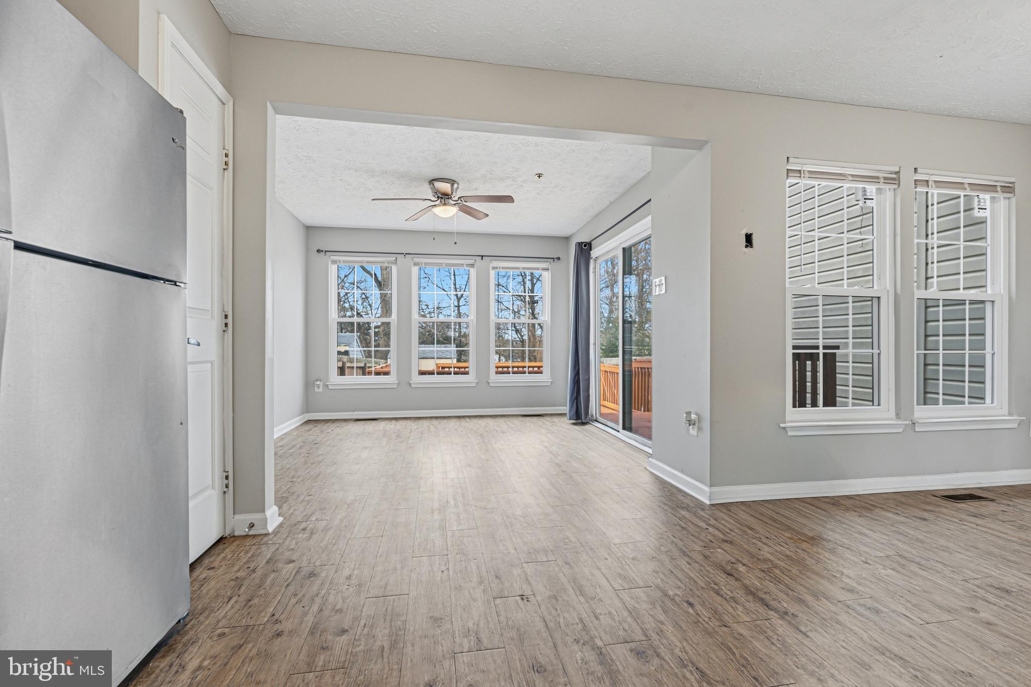 536 MacIntosh Circle Joppa, MD 21085 - Photo 5 of 32 a view of an empty room with wooden floor and a window