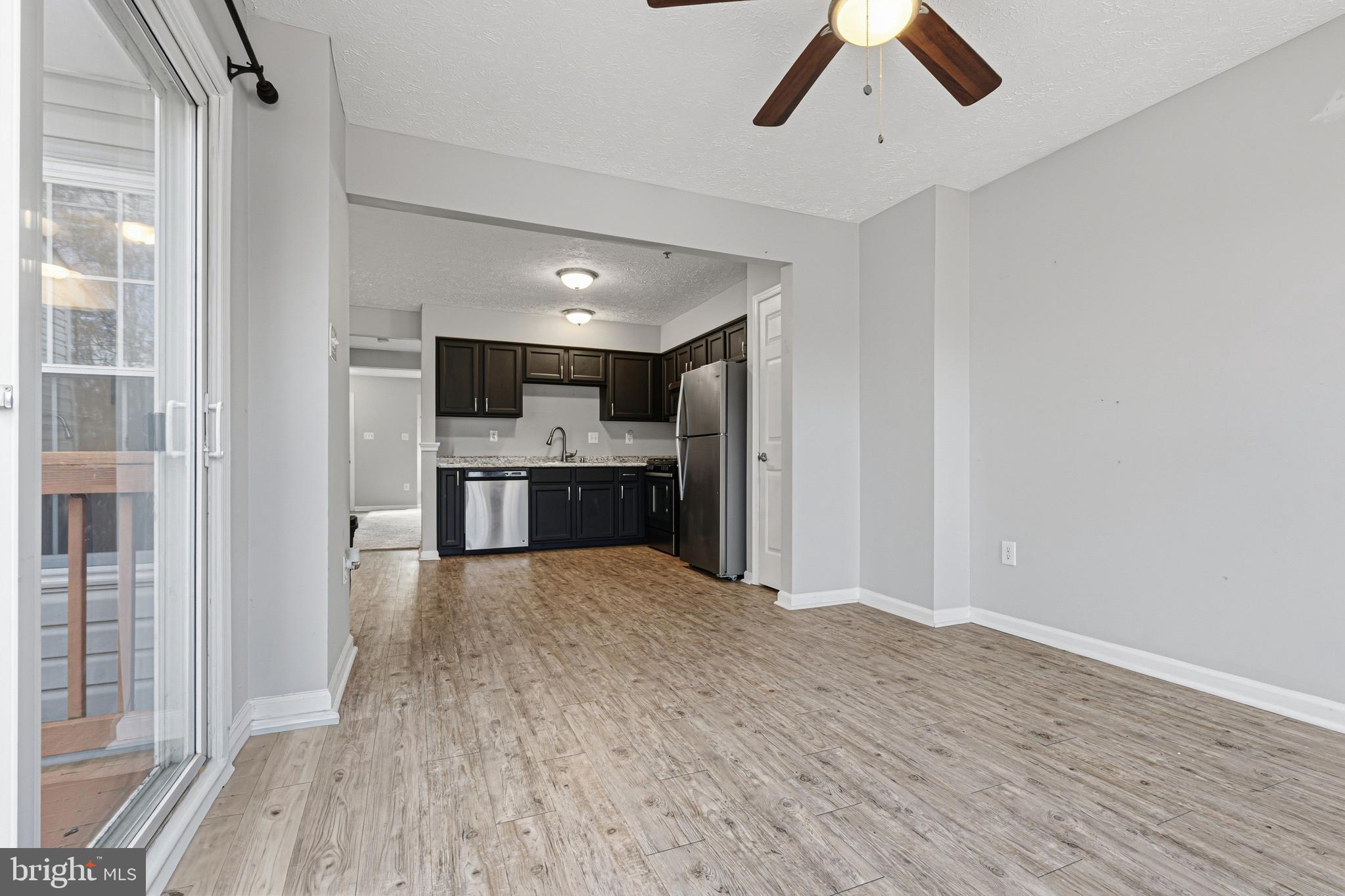 536 MacIntosh Circle Joppa, MD 21085 - Photo 7 of 32 a view of kitchen with refrigerator microwave and wooden floor