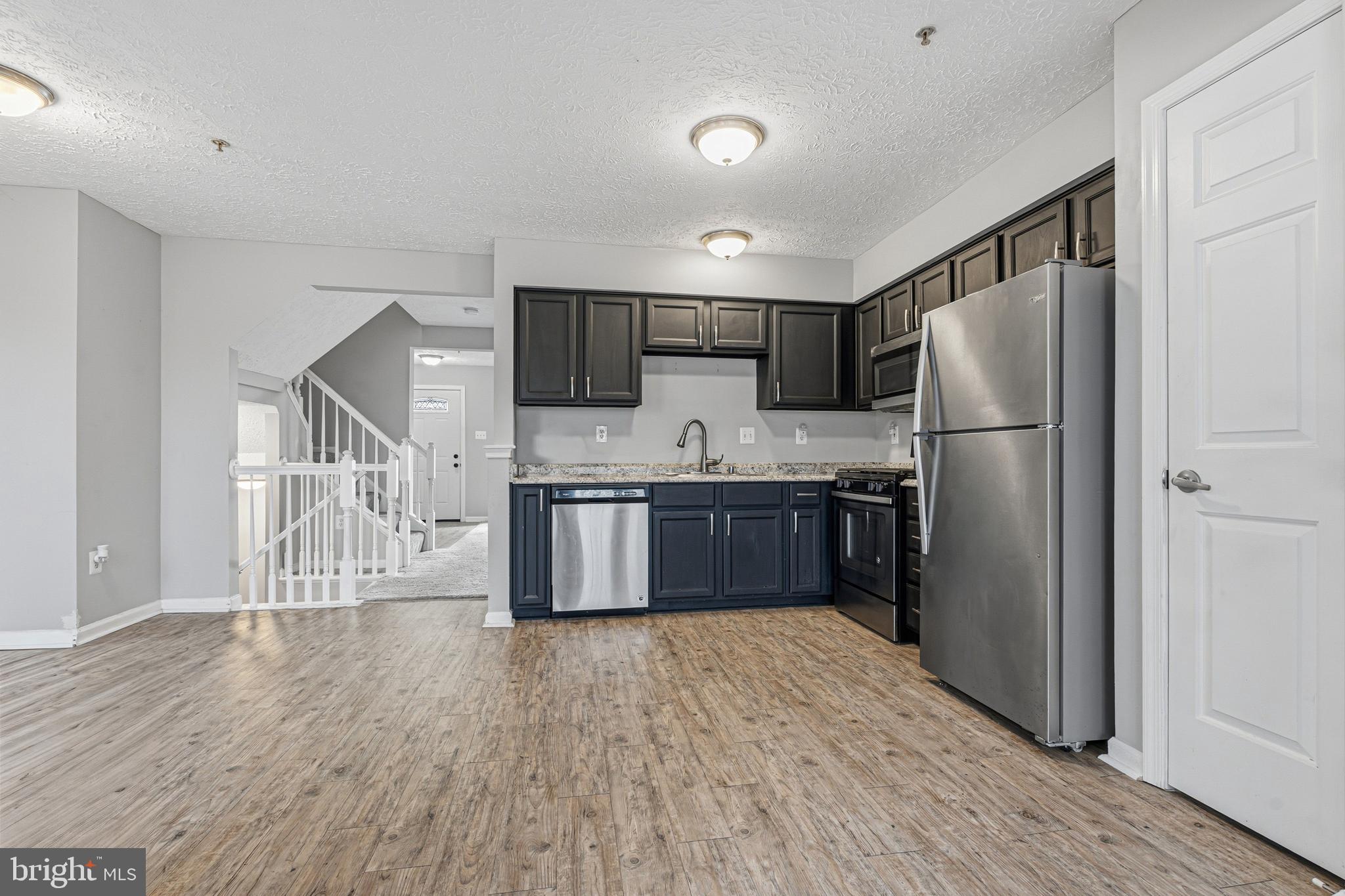 536 MacIntosh Circle Joppa, MD 21085 - Photo 8 of 32 a kitchen with stainless steel appliances a refrigerator and a stove top oven