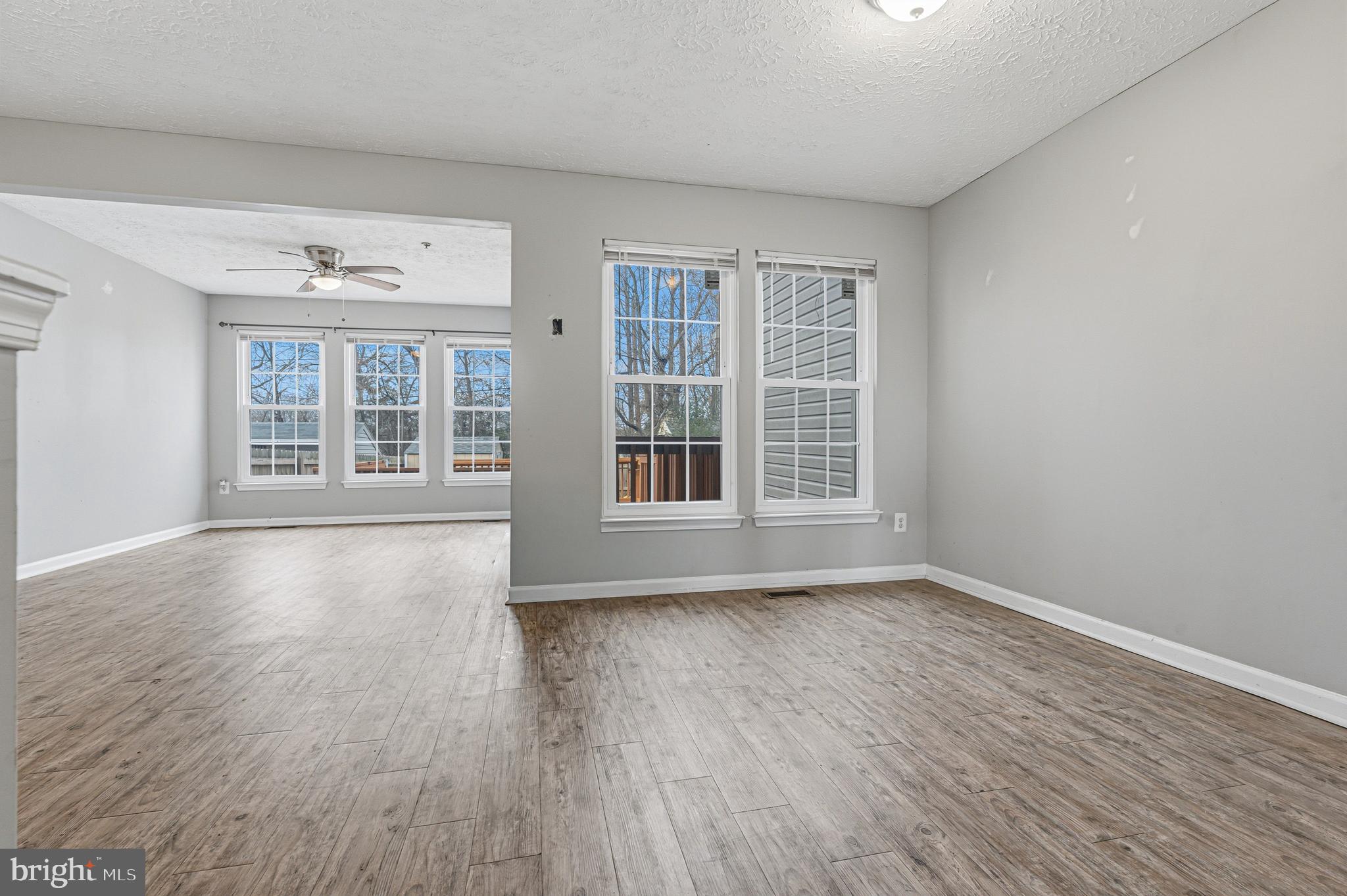 536 MacIntosh Circle Joppa, MD 21085 - Photo 10 of 32 a view of an empty room with wooden floor and windows