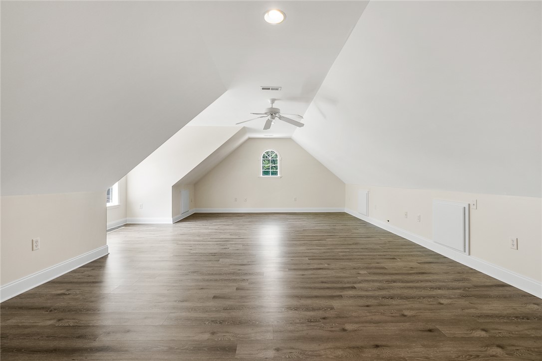 135 Sunset Bay Boulevard Seneca, SC 29672 - Photo 39 of 50 A spacious, naturally illuminated attic space with peaked ceilings and rich wood flooring.