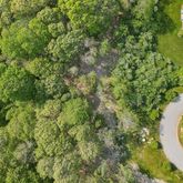 an aerial view of a house with a yard and lake view