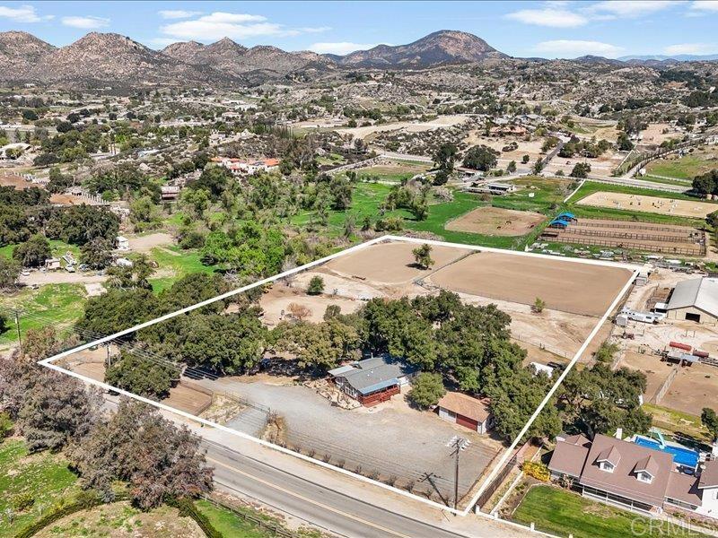 an aerial view of residential houses with outdoor space and street view