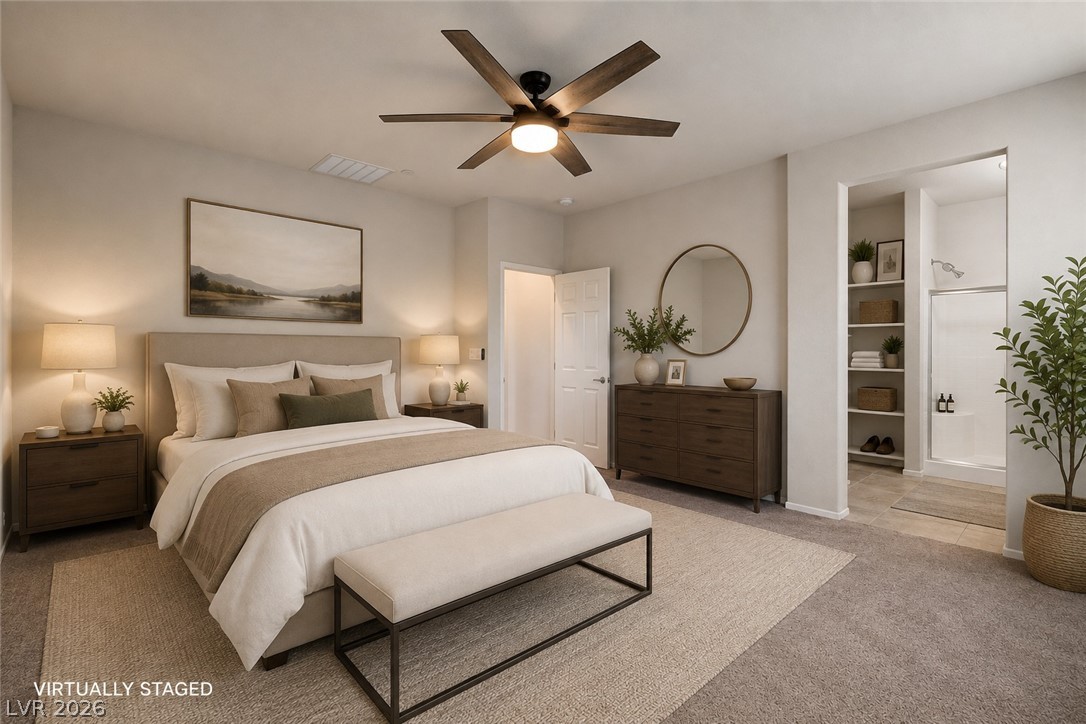 2185 Rio Rancho Pointe Place Henderson, NV 89002 - Photo 5 of 17 An inviting bedroom retreat features a ceiling fan, plush carpet, and a private en-suite bathroom.
