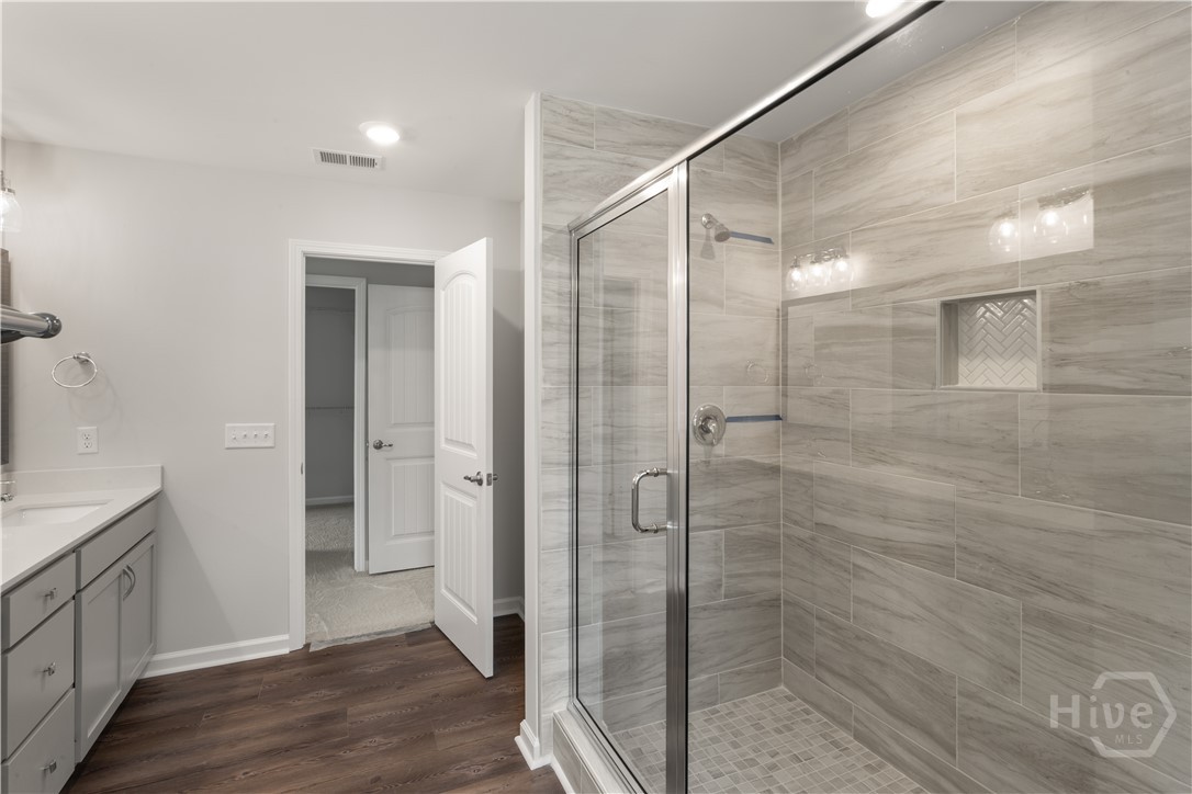29 Blues Drive Pooler, GA 31322 - Photo 33 of 40 Primary bathroom features double vanities w/ a quartz top, framed mirror, and a large 6' tiled shower-only with a bench! Private water closet.