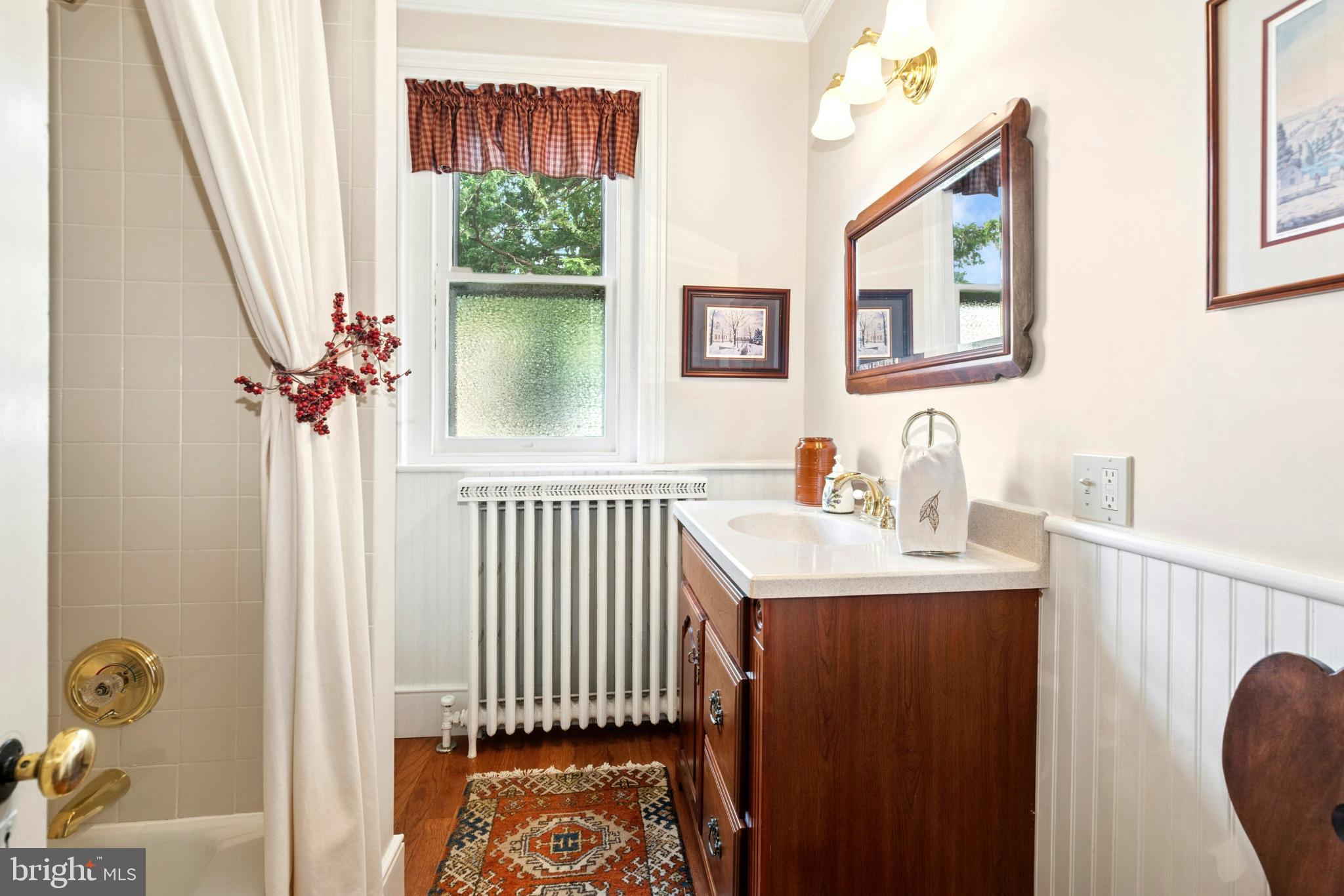 72-74 West Market Street Bethlehem, PA 18018 - Photo 24 of 36 a bathroom with a sink a mirror and a window