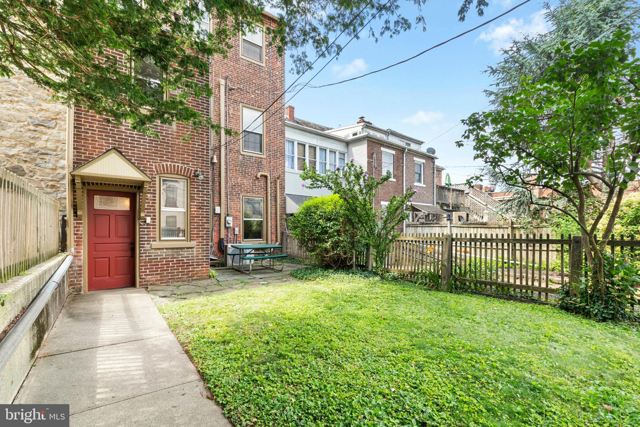 72-74 West Market Street Bethlehem, PA 18018 - Photo 35 of 36 a view of a brick house with a yard and table and chairs under an umbrella