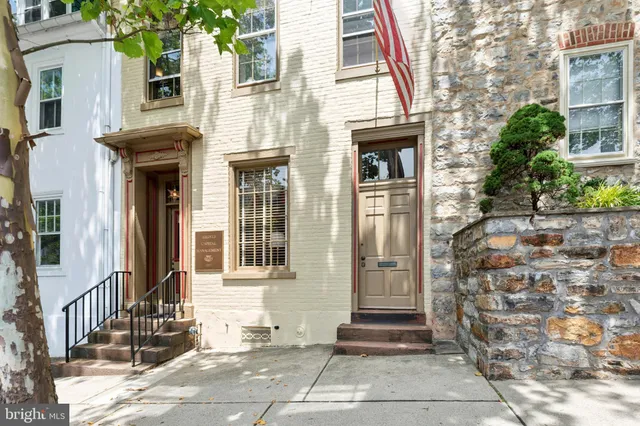 a front view of a brick house with a large windows